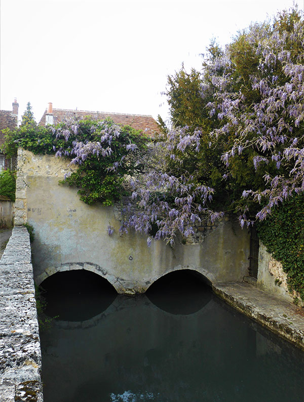 Cour des forges, Ferrières-en-Gâtinais, passage du bras artificiel de la Cléry sous les habitations des tanneurs.